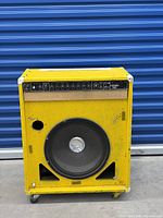 Full view of yellow Peavey Combo 300 bass combo amp on casters