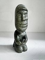 Front view of signed soapstone kneeling figure