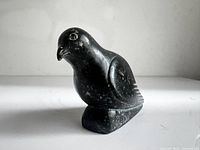 Side view of dark soapstone bird carving