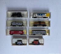 Overview of eight N scale items in plastic cases