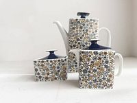 Full view of teapot, creamer and sugar bowl showing pattern and form