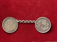 Front view of both 1 Krone coins connected by chain