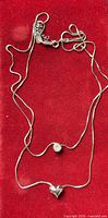 Full view of sterling silver necklace showing chain, pendants and clasp