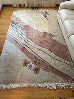 Full view of 6x9 wool rug on floor showing design, color, fringe