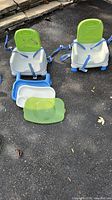 Both booster seats with trays and straps visible