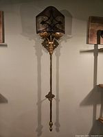 Full view of tall gilded metal wall sconce