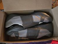 Pair of shoes inside box, side view