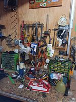 Overall bench and wall view showing hand tools, hammers, wrenches, pliers, snips, levels, hardware organizers