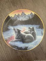 Full view of signed ceramic plate showing wolf artwork and gold rim