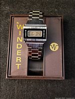 Front view of Windert digital wristwatch resting on branded box lid displaying 6:34