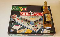 Puzz3D Monopoly box next to Sunflowers puzzle bottle
