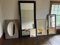 Group shot of four mirrors leaning against wall