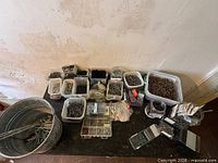 overview of table with multiple bins of fasteners and bucket