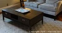 Full view of coffee table showing drawers, cubby, legs and surface wear