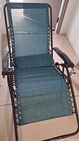 Unfolded chair showing fabric, frame, and headrest