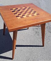 Full view of square walnut table with tapered legs