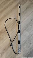 Full view of 4-foot steel power strip with attached cord