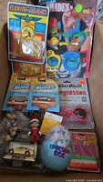 Overview of box showing packaged toys and novelties