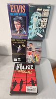 Front view of five tapes/discs showing titles and cover art
