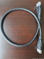 Full view of 3 ft HDMI cable coiled showing both male connectors and printed high speed marking