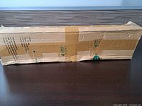 Sealed rectangular brown shipping box containing Lazy Whale bracket