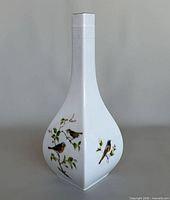 Front view of white porcelain vase with bird motif
