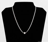 Necklace displayed on bust showing two strands and slide bead