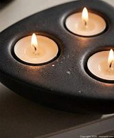 Top view showing three lit tealights in holder