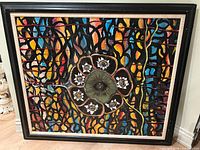Full view of framed painting showing overall design and frame