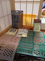 Group shot of all stencils, brass template, sequins pack, card templates and corner mouldings