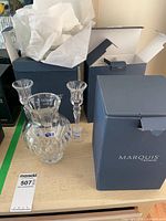 Vase, two candlesticks and boxes displayed on table