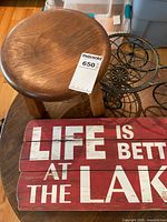 wood stool, wire planter, portion of lake sign