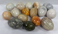 Full group of 16 polished stone eggs, various colors