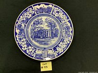 Front of blue and white Lee-Jackson Home plate showing scenic design and floral border
