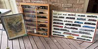 Overall view of display cabinet with model trains and two framed posters