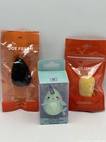 Three packaged makeup sponges front view