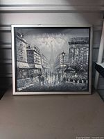 Full view of framed print showing Paris street scene and metal frame