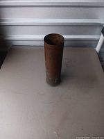 Full side view of brass shell casing standing upright