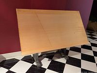 Full view of drafting table showing wood top and adjustable angle