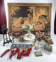 Group shot showing all decorative items including framed tapestry, footstool, metal easels, porcelain pieces, candleholder, mold, trinket box, peppers and tile