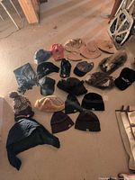 Group view of all hats and scarf spread on floor