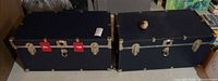Pair of navy steamer trunks side by side