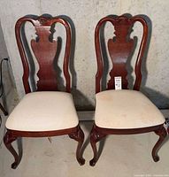 Front view of both dining chairs showing design and upholstery