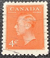 Close-up of the orange 4¢ King George VI stamp showing design, color, and postmark
