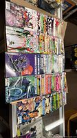 Top view of stacked DC comic books showing Birds of Prey, Batgirl, Gotham City Sirens and Batman Harley & Ivy covers