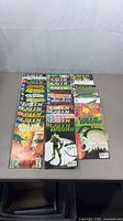 Front view of all 35 Green Arrow comics laid out on table