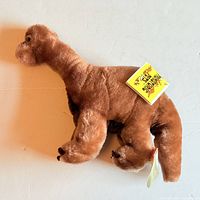 Left side view of plush showing overall form and hangtag