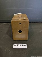 Front view showing lens, brown leatherette covering