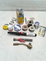 Entire lot overview showing iron, torch heads, solder spools, flux, tips