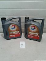 Front view of two 5 L Total Quartz 0W-40 motor oil containers